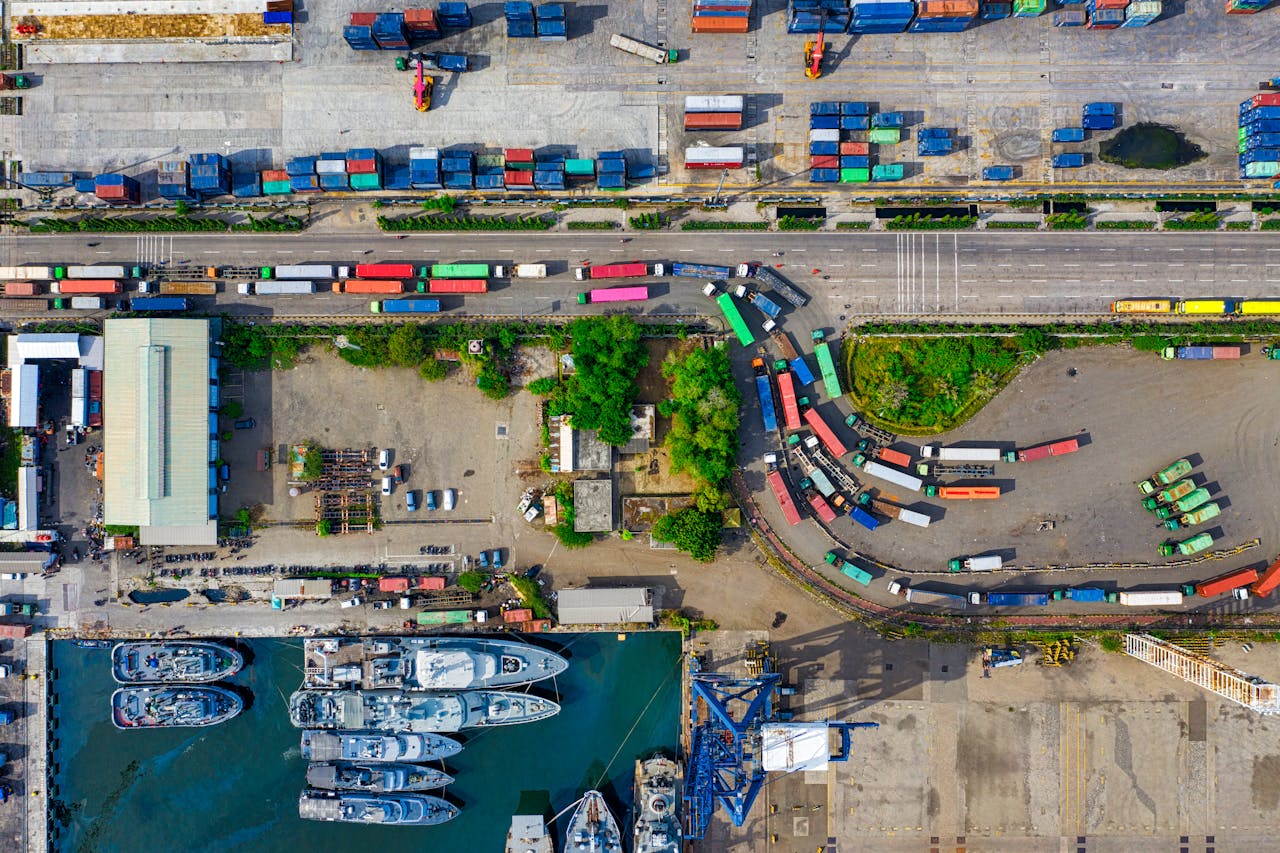 services-03 A vibrant aerial view of an industrial port with cargo containers in North Jakarta, Indonesia.